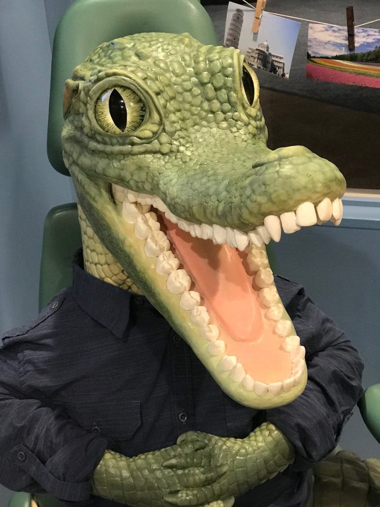 crocodile smiling in dental chair