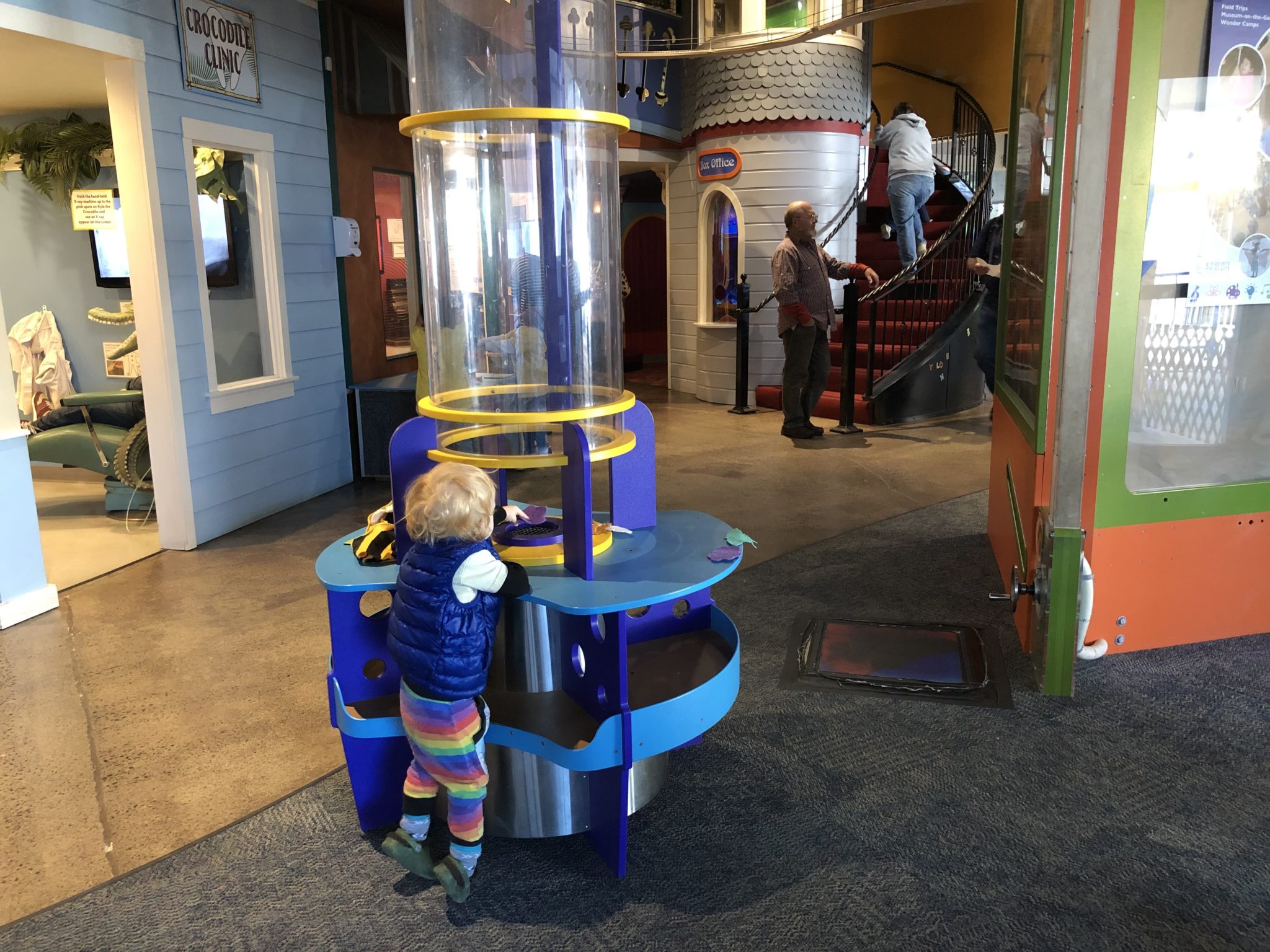 child playing with wind vortex tube