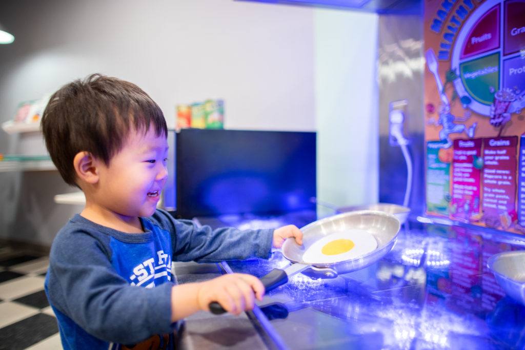 kids playing at pretend stove