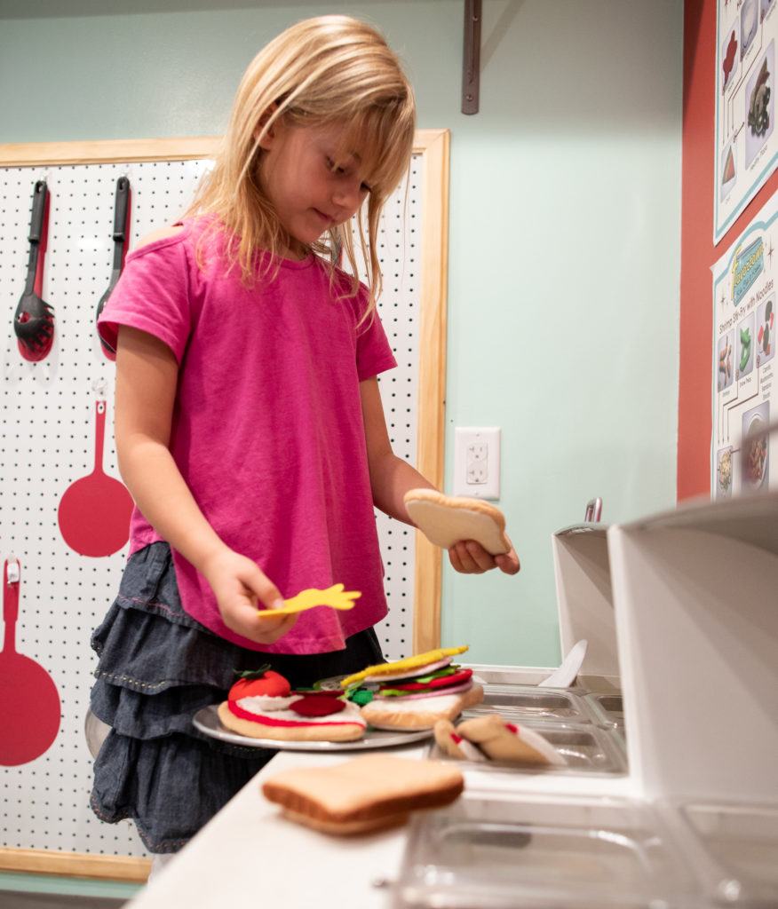 child making sandwiches from felt