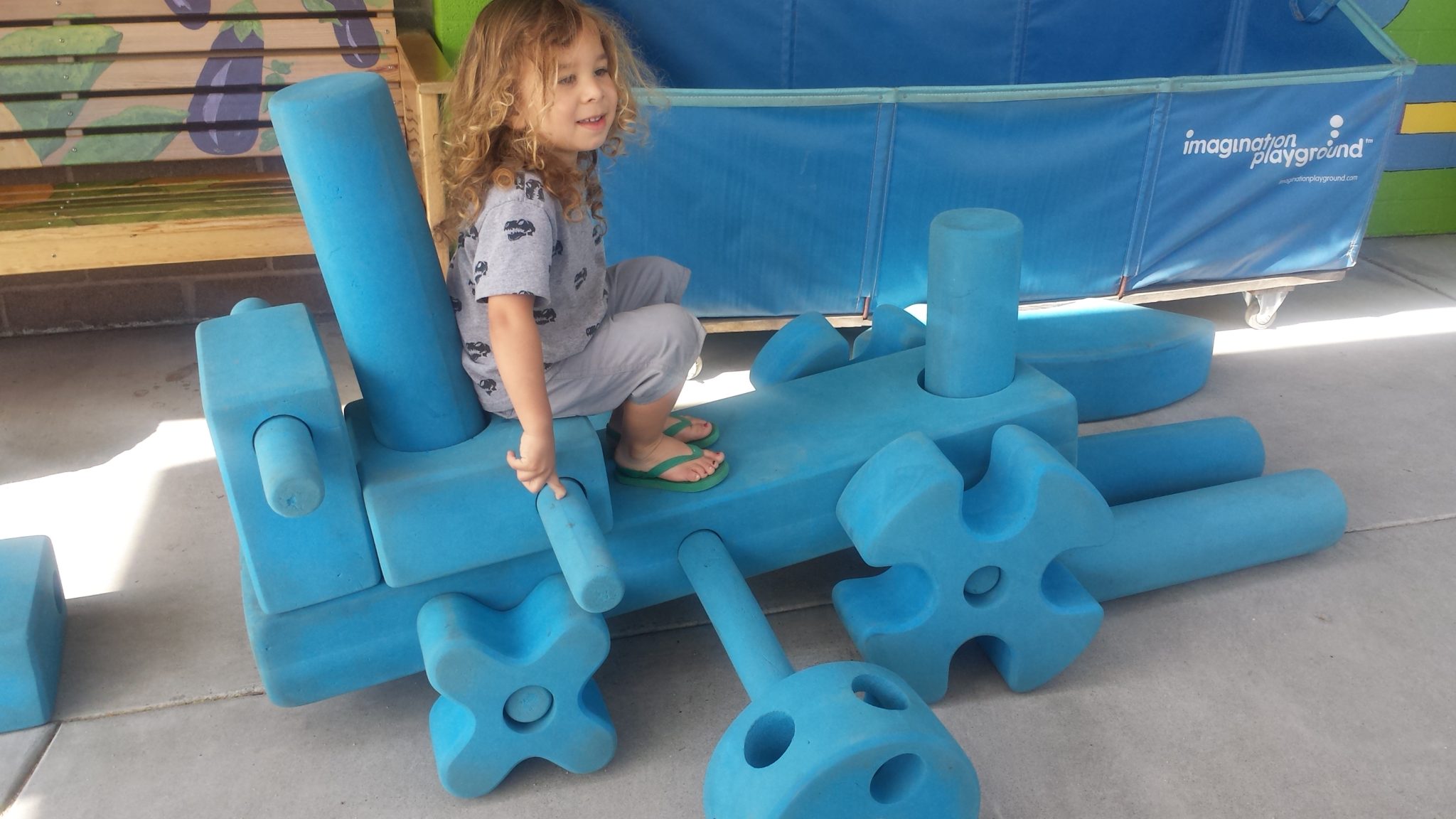 child playing in blue blocks area