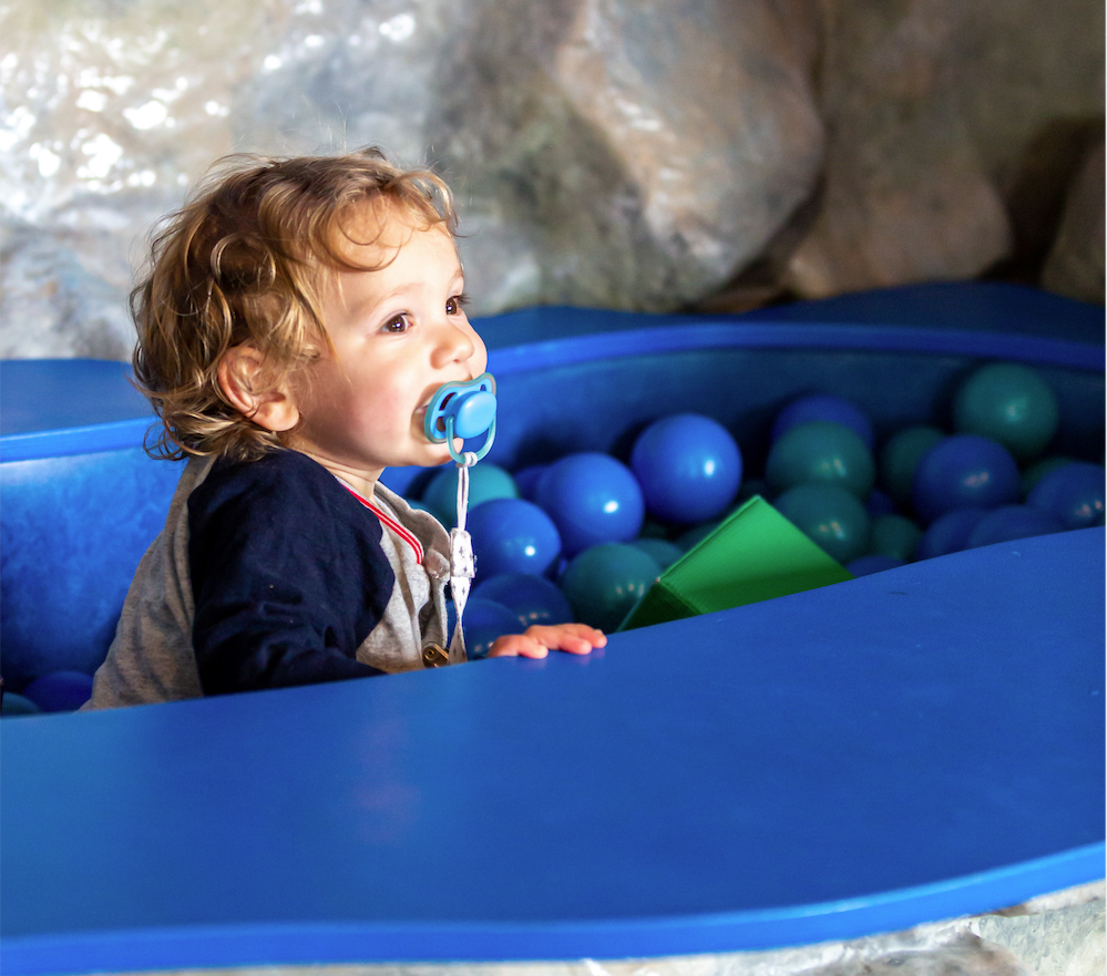 Child playing in ball pit