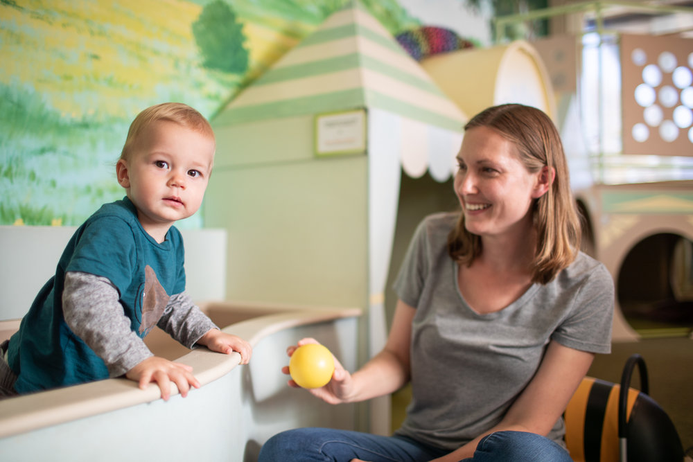 adult and child playing in playroom