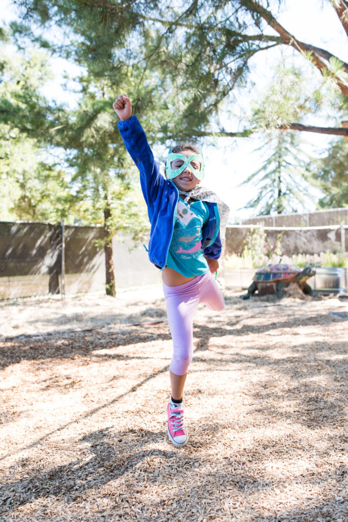 child wearing superhero mask