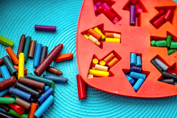 making homemade cookie crayons old crayons by melting them in the oven in a silicone cookie sheet