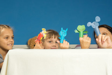 children and mom play with homemade paper finger puppets