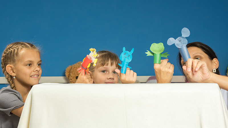 children and mom play with homemade paper finger puppets