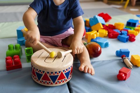 toddler playing with a drum and having fun