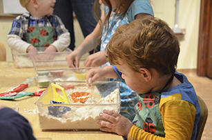 child playing with sensory sand foam