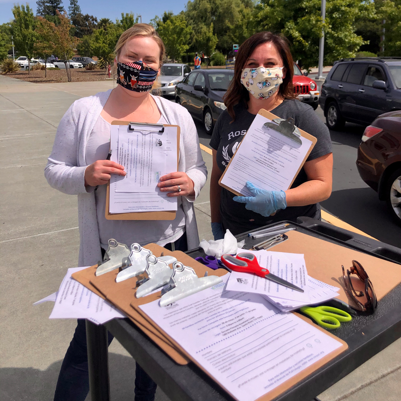 two women holding enrollment form