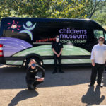 childrens museum staff socially distanced in front of van