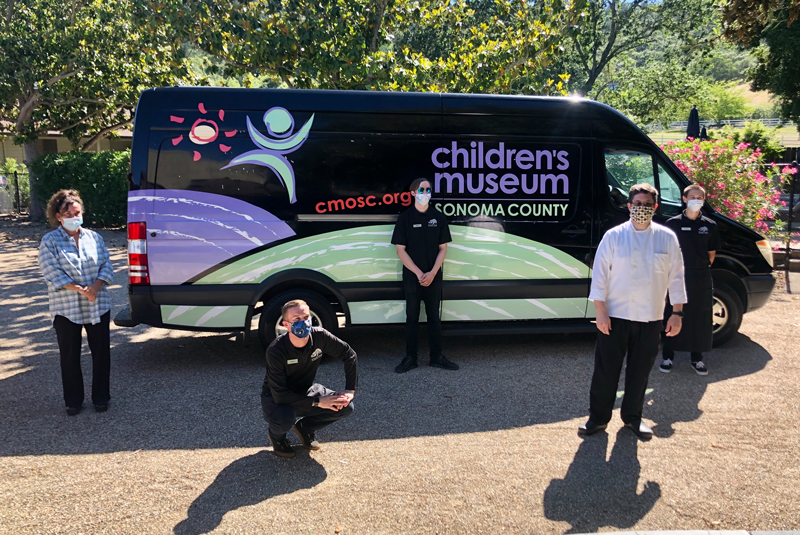 childrens museum staff socially distanced in front of van