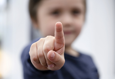 child pointing with index finger 