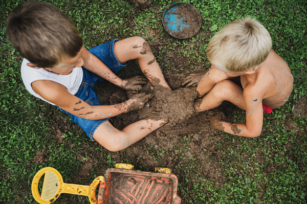 toddler mud play with two children