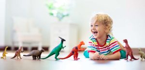 very happy child playing with colorful toys