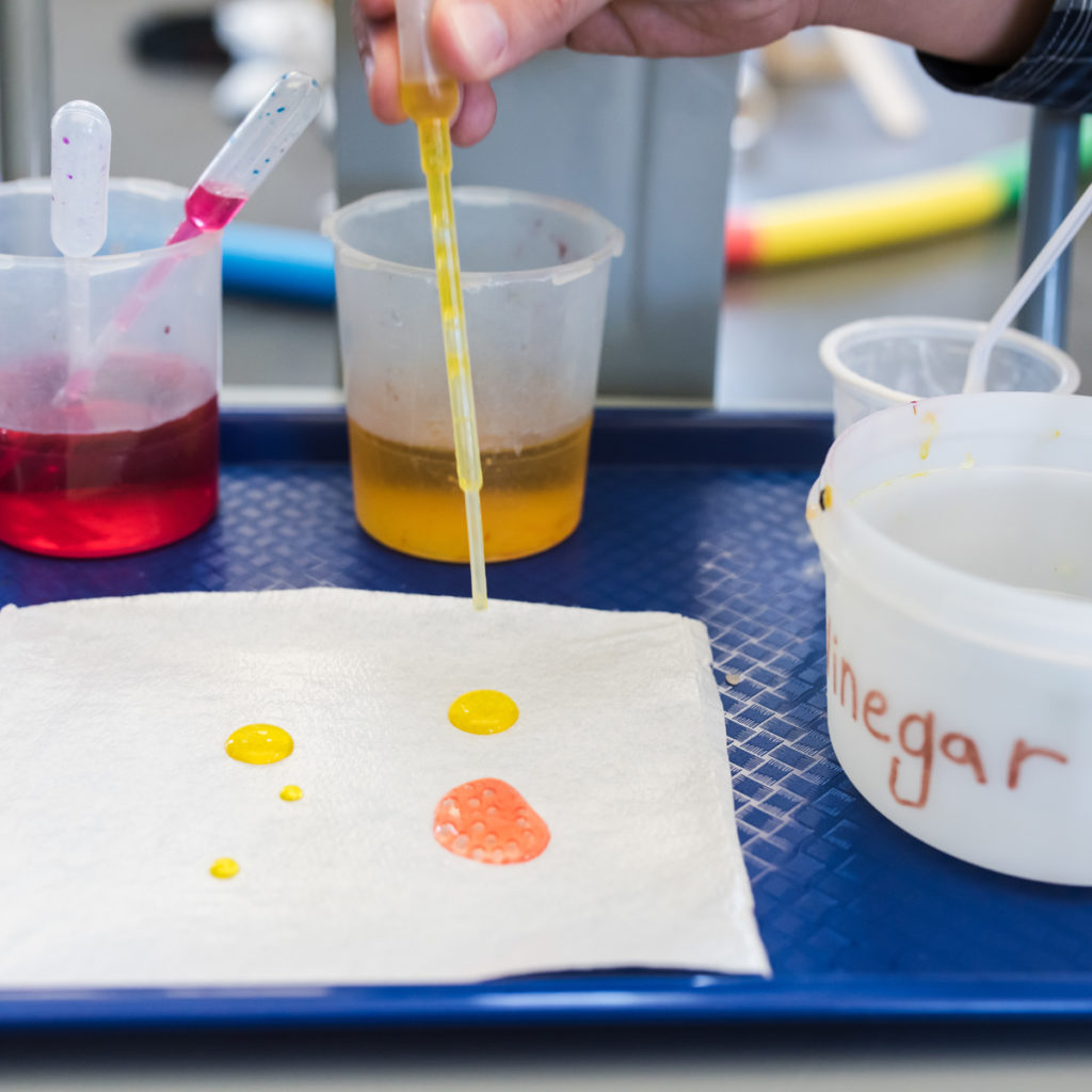 pipette dripping colored water onto cloth