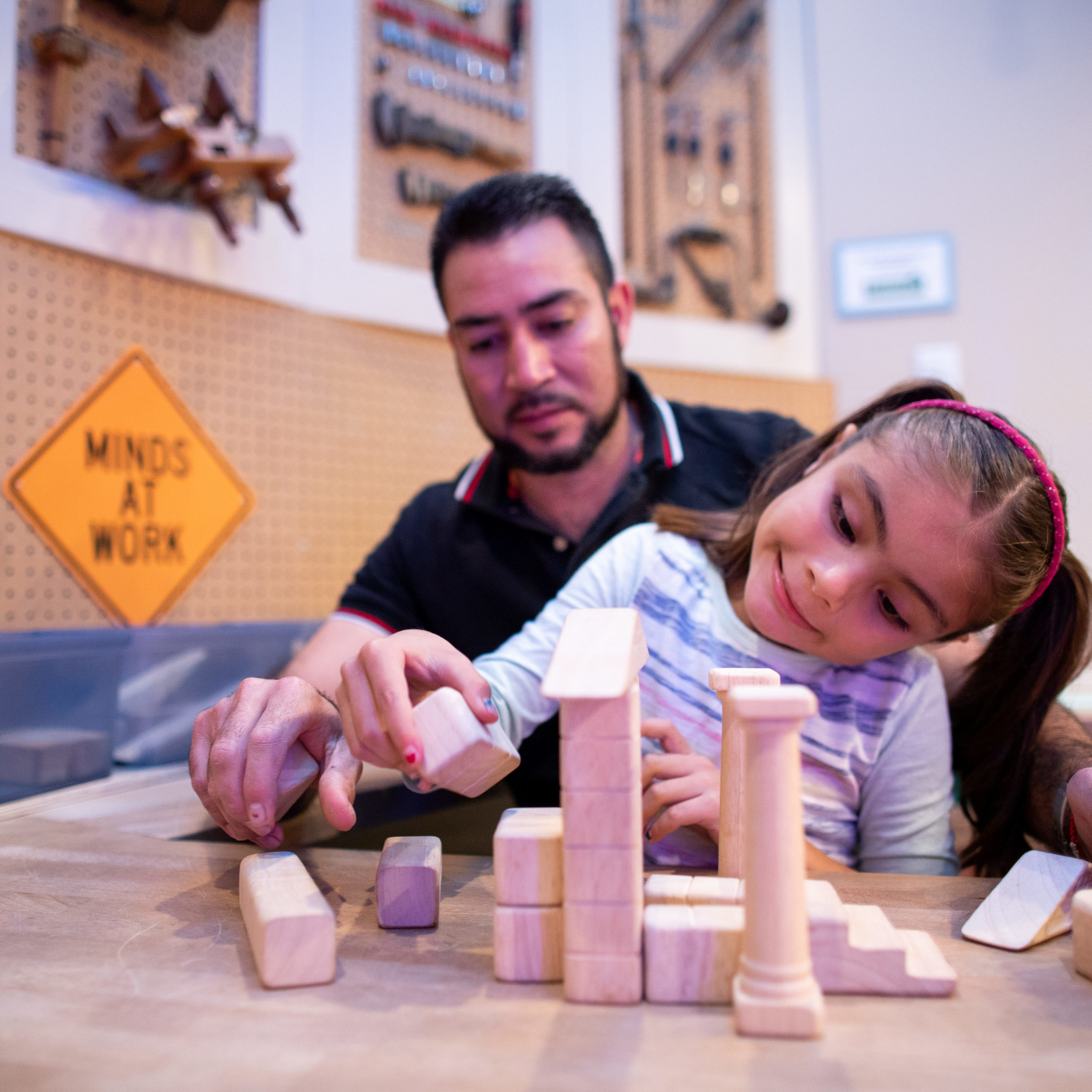 father and daughter playing with blocks