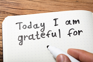 Close-up Of A Person Writing Today I Am Grateful For Text On Notebook With Marker