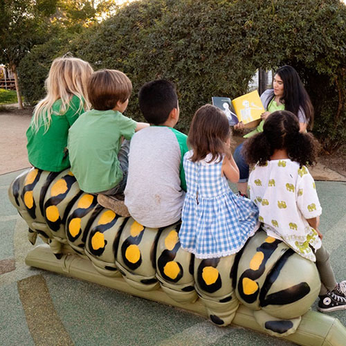 children enjoying Storytime at the Children's Museum of Sonoma County sitting on the Storybook Caterpillar