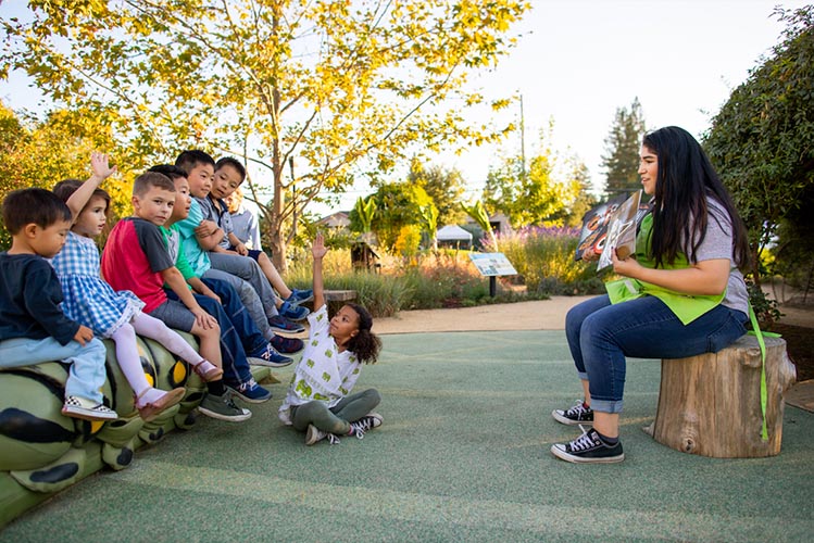 children enjoying Storytime at the Children's Museum of Sonoma County sitting on the Storybook Caterpillar