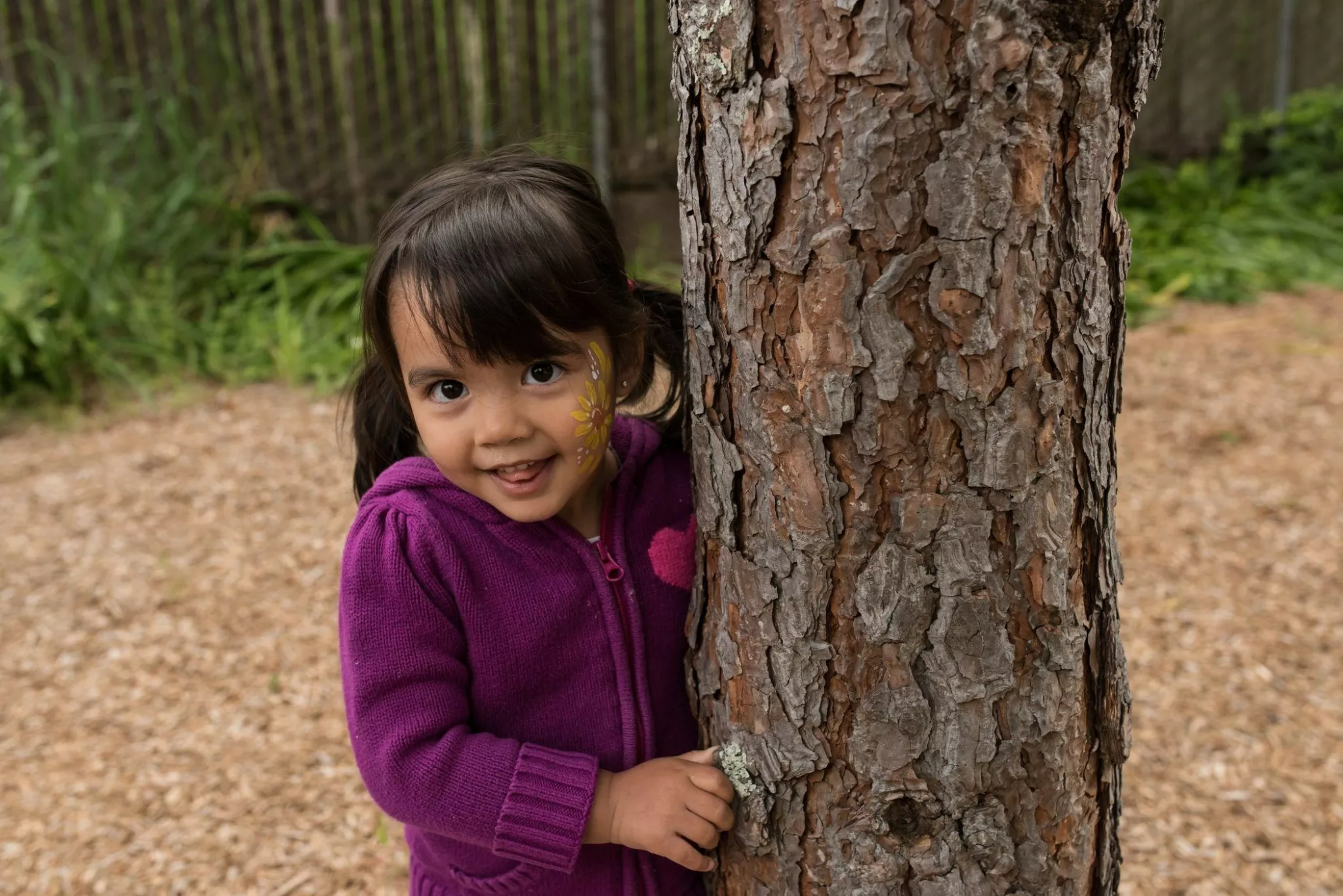 child next to tree