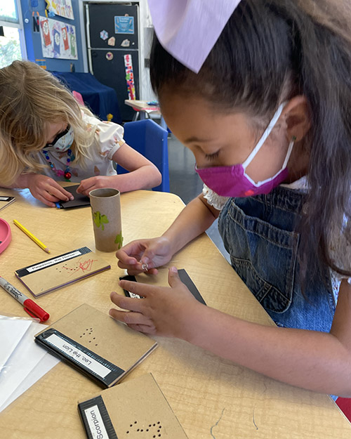 Two children making constellation telescopes at the Children's Museum of Sonoma County