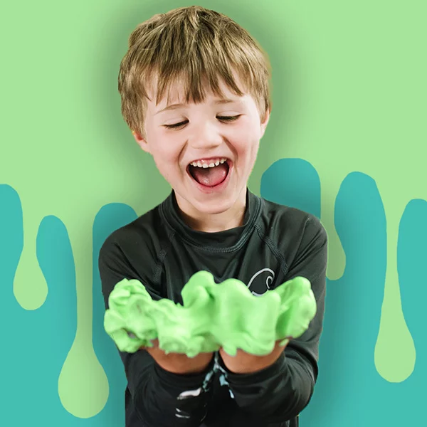 Child playing with Oobleck made during a Halloween Activity for kids