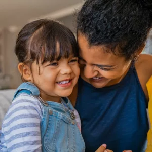 young mother laughs with her toddler