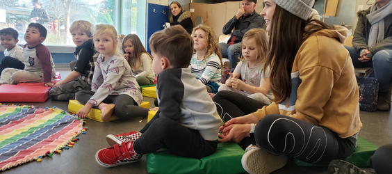 Children sitting down for Stories with Ms.Laurie