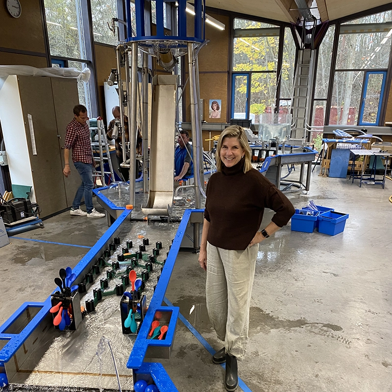 Children's Museum, CEO and Founder, Collette Michaud standing next to the Mechanical Waterways 2.0 Waterplay Exhibit at Hüttinger Interactive Exhibitions in Nuremberg, Germany where it was built.