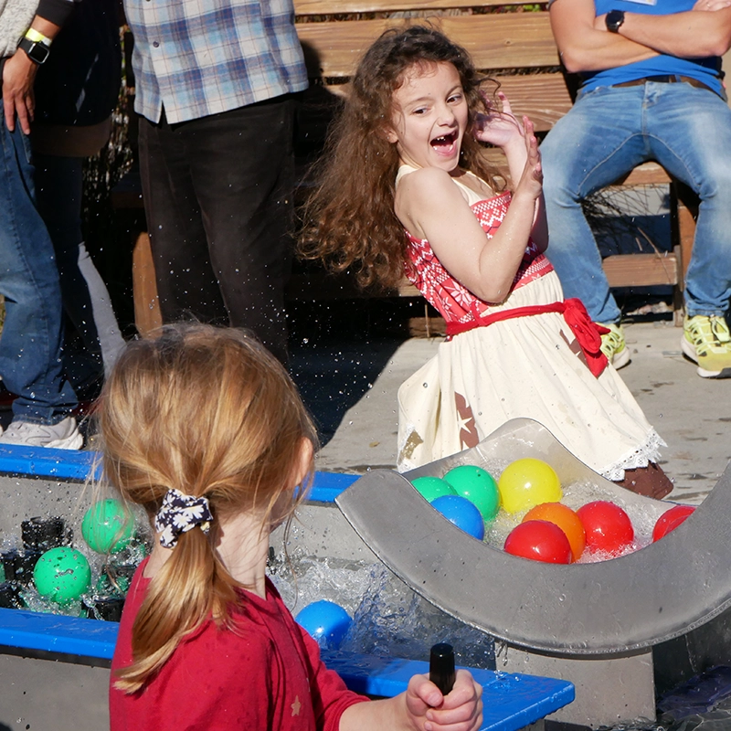 children happily playing with the Mechanical Waterways 2.0 Waterplay Exhibit at the Children's Museum of Sonoma County