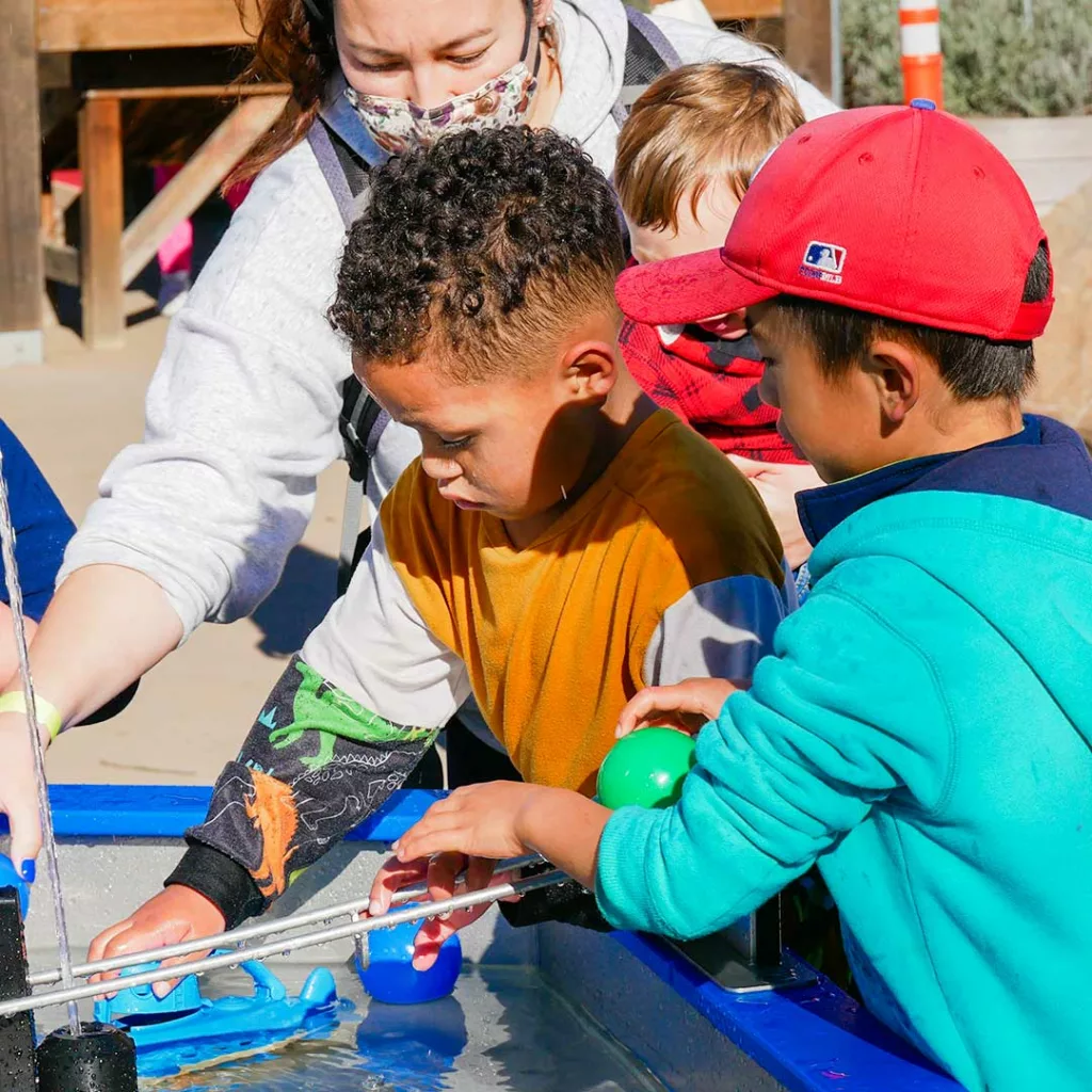 children playing with the new waterways exhibit at the children's museum