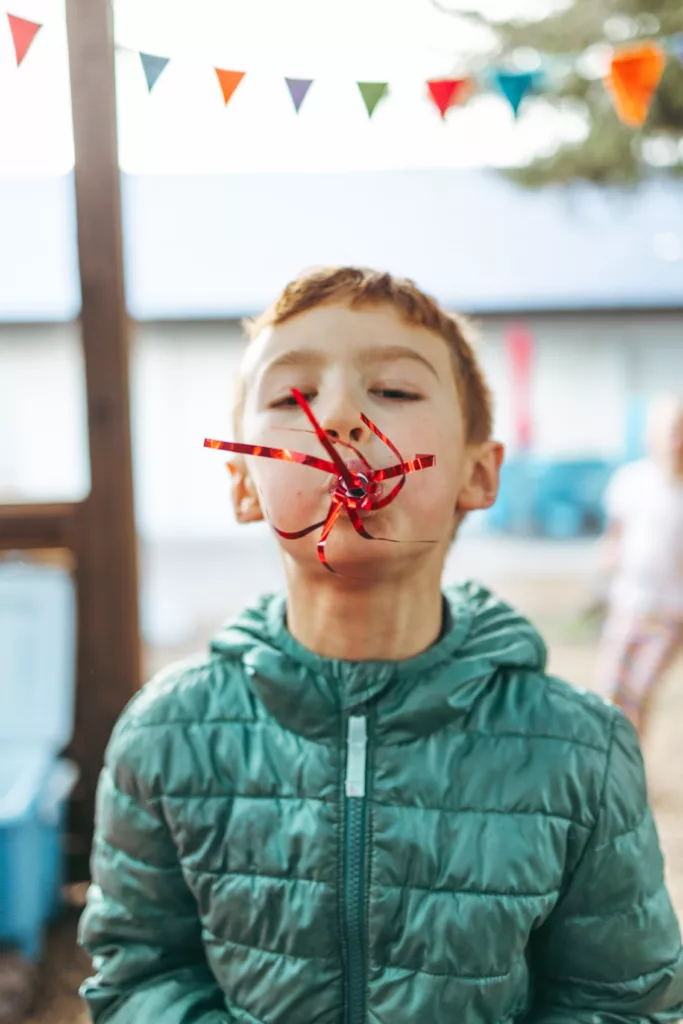 child play with a party streamer at a birthday party at the Children's Museum