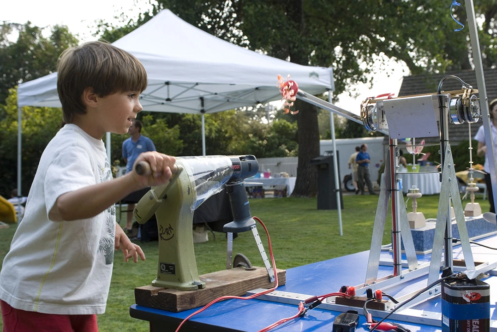 Children playing with interactive, educational activities brought to local community events by the Museum-on-the-Go program circa 2005-2010.