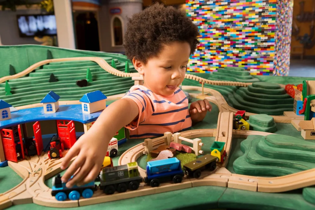 A young child playing at the Mini Train Town interactive exhibit at the Children’s Museum of Sonoma County, in Santa Rosa, CA.
