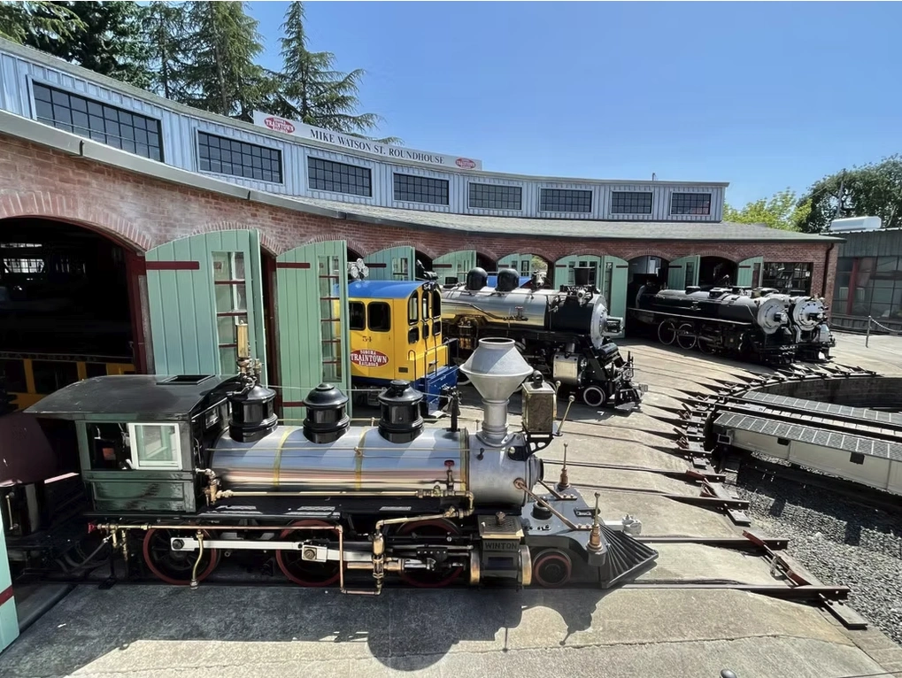 A roundhouse filled with a diverse collection of antique cabooses and locomotives at Sonoma TrainTown Railroad in Sonoma, Ca.